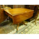 An early 19th century mahogany Pembroke breakfast table of usual form, raised on a turned pillar,