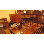 A late Regency mahogany sofa table fitted with two real and two dummy drawers with fall flap to