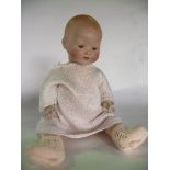 A German bisque headed doll by Armand Marseille marked to neck A.M Germany 351./4/K with painted