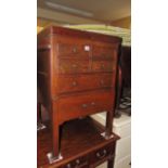 A George III mahogany fold over top washstand, the front elelvation enclosed as a series of drawers,
