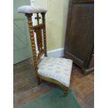 A 19th century prayer chair with upholstered seat and rail, the fruitwood framework with bobbin