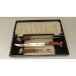 A good quality cased carving trio, all with worked antler handles, terminating in applied white