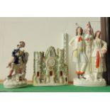 A large 19th century Staffordshire figure group of male and female characters flanking a vase with