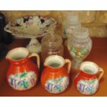 A set of three 19th century orange ground graduated jugs with printed and infilled chinoiserie