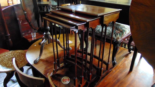 A nest of four Georgian style mahogany occasional tables of rectangular form on slender moulded