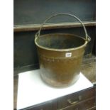 A 19th century copper pail with ironwork handle and riveted detail, 35 cm diameter