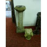 A 2-sectional weathered composition stone sundial, the column with floral and classical figure