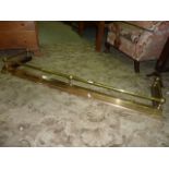 A Victorian style brass fire curb with turned rail and adjustable framework, 165cm maximum, 135cm