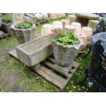 A pair of weathered cast composition stone circular tapered fluted urns raised on square cut