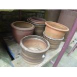 A small quantity of contemporary garden planters of varying size and design including brown matt