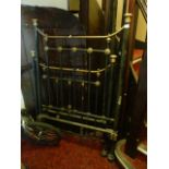 A Victorian brass and iron single bedstead with black painted vertical turned bars