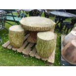 A novelty hollow cast composition stone low garden table and four matching stools to simulate tree