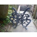A pair of reproduction cast iron bench ends with lions mask terminals and scrolled supports,