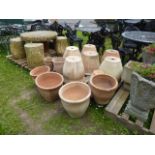 A quantity of contemporary terracotta garden planters/jardiniŠres of circular tapered form and of