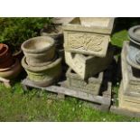 Seven cast composition stone garden planters, four square cut and three circular examples, all