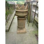 A reclaimed buff coloured crown top chimney pot