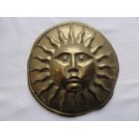 A brass sun insurance plaque of simple rounded form, 6cm diameter approximately