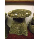 A weathered natural stone staddle stone of tapered form with domed cap