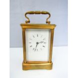 A brass carriage clock, with enamel dial and 8 day time piece