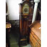 A good quality Edwardian oak grandmother clock set within a panelled case, the hood with barley