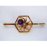 A 9ct gold bar brooch, centred with a gem-set spider motif within a hexagonal border, 3.7g,