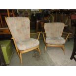 An Ercol light beechwood framed high hoop and stickback open armchair raised on splayed supports,