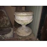 A 19th century or possibly earlier stone font/urn, the circular lobed bowl raised on a tapered