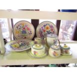 A collection of Poole Pottery wares comprising: three circular dishes with floral decorations and