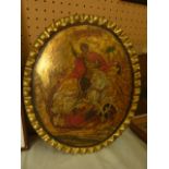 A 19th century Eastern European icon of oval form on a wooden panel with painted and gilded