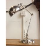 A contemporary three jointed anglepoise type tall desk lamp with butterfly hinges, raised on a