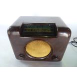 A brown faux timber grain Bakelite cased 20th century Bush radio over two short and one medium