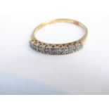 A diamond ring, set with nine single-cut diamonds, each within a square border, in 18ct gold and