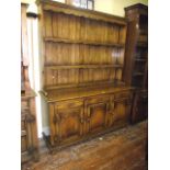 A good quality reproduction oak dresser in the tradition old English style with distressed finish,