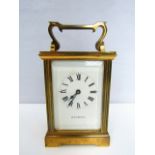 A brass carriage clock with enamel dial and 8 day time piece, Jean Renet