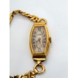 A lady's 18ct gold wristwatch, Rolex, circa 1930's, the tonneau shaped dial with black Arabic