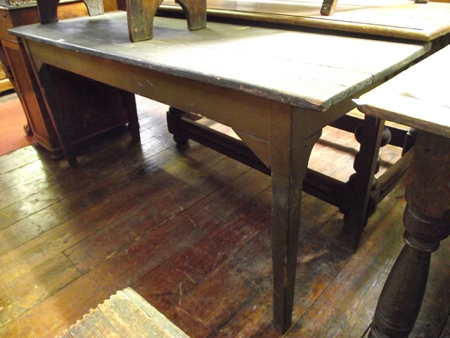 A 19th century stained and painted pine kitchen table of rectangular form raised on four square