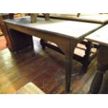 A 19th century stained and painted pine kitchen table of rectangular form raised on four square