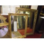 A contemporary wall mirror of rectangular form with bevelled edge plate within a moulded gilt