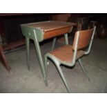 A vintage cast metal framed and green painted child's school desk and matching chair stamped 'E.S