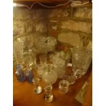 A collection of glassware to include a pair of clear cut toilet water bottles with silver collars