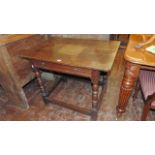 An 18th century oak side table with rectangular plank top over a shallow frieze drawer raised on