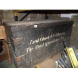 A vintage stained pine and steel reinforced travelling trunk/chest with hinged lid and iron work