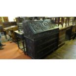 A 19th century carved oak two sectional writing bureau with scrolling acanthus and further detail,