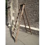 A vintage eight rung A framed folding wooden step ladder (to be sold for decoration purposes only)