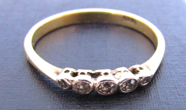 A diamond ring, set with five graduated old-cut diamonds, in 18ct white and yellow gold, size T