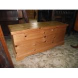 A stripped pine blanket box with hinged lid and moulded detail