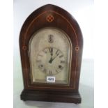 An Edwardian lancet shaped mantel clock with boxwood string inlay, the arched silvered dial with