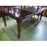 A Victorian style mahogany pull-out extending dining table of rectangular form with moulded