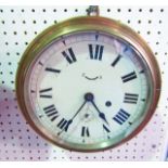 A brass fronted bulk head marine clock with eight day timepiece (maker Seth Thomas according to