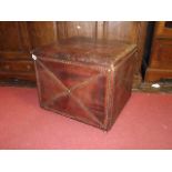 An old English style tan leather clad box stool with hinged lid and applied brass studwork detail